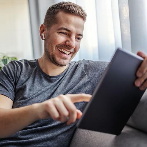 Man on sofa with tablet